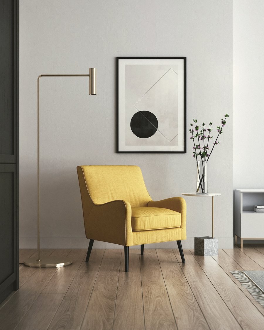 The Lune arc lamp beside a yellow armchair