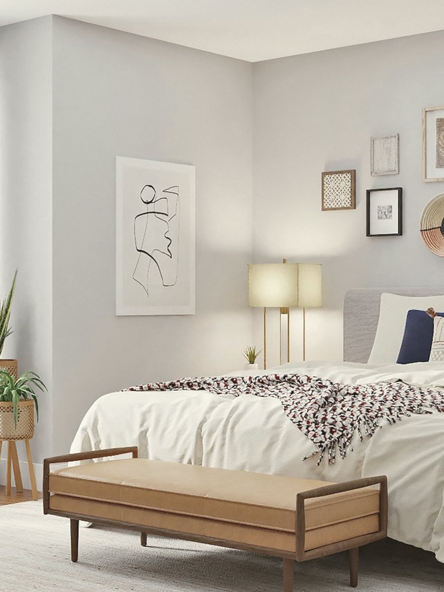 Bedroom with washed linen, low light and a timber bench
